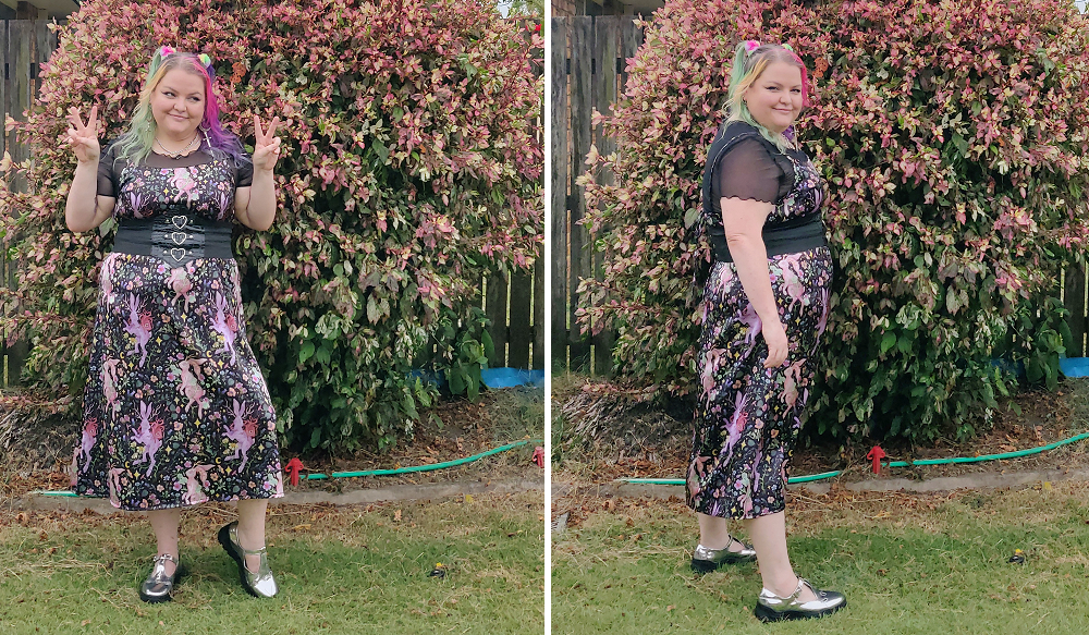A chubby gal wearing a short sleeve lettuce hem mesh shirt with a midi length spaghetti strap dress in a floral and rabbit print dress. She wears silver mary jane shoes and a thick corset like beth with 3 silver hearts.