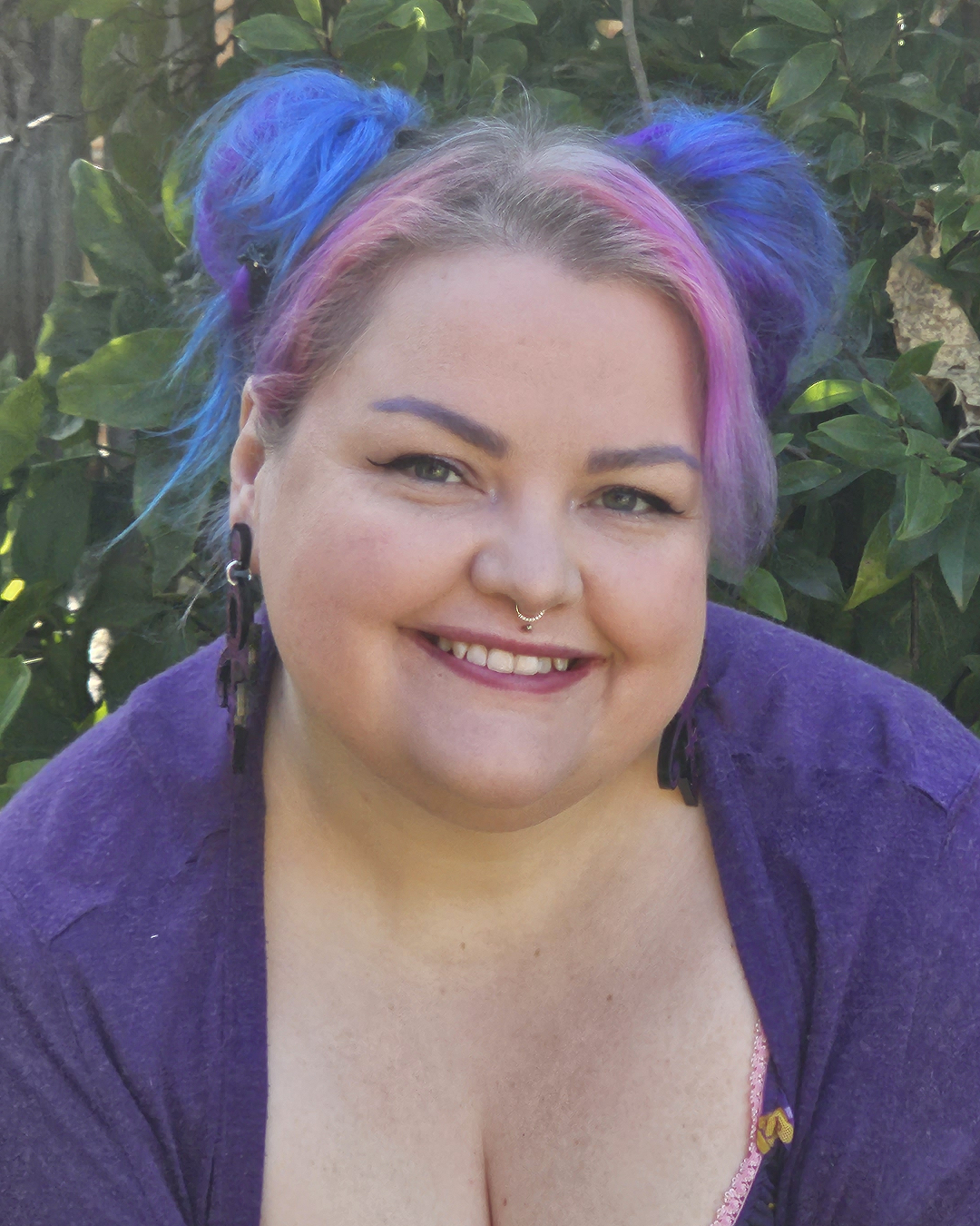 Plus sized girl with pink and purple hear wearing a purple care bears dress