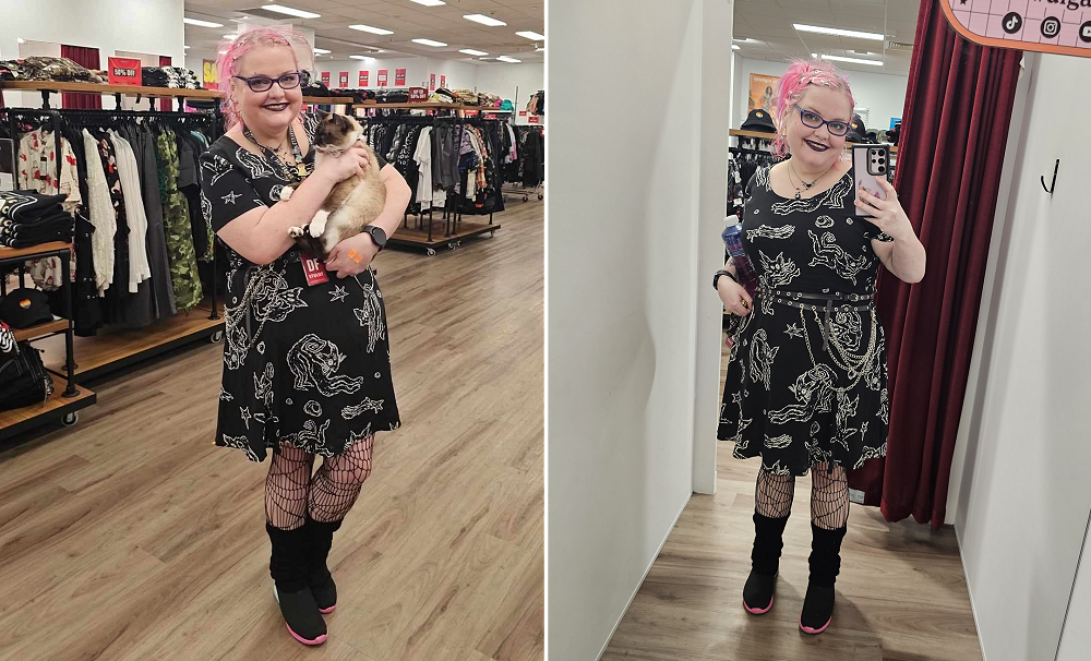 Chubby girl with pastel pink hair wearing a black dress with white artistic cats on it. In the left picture she is holding a cat, in the right, she is taking a photo in a dressing room mirror.