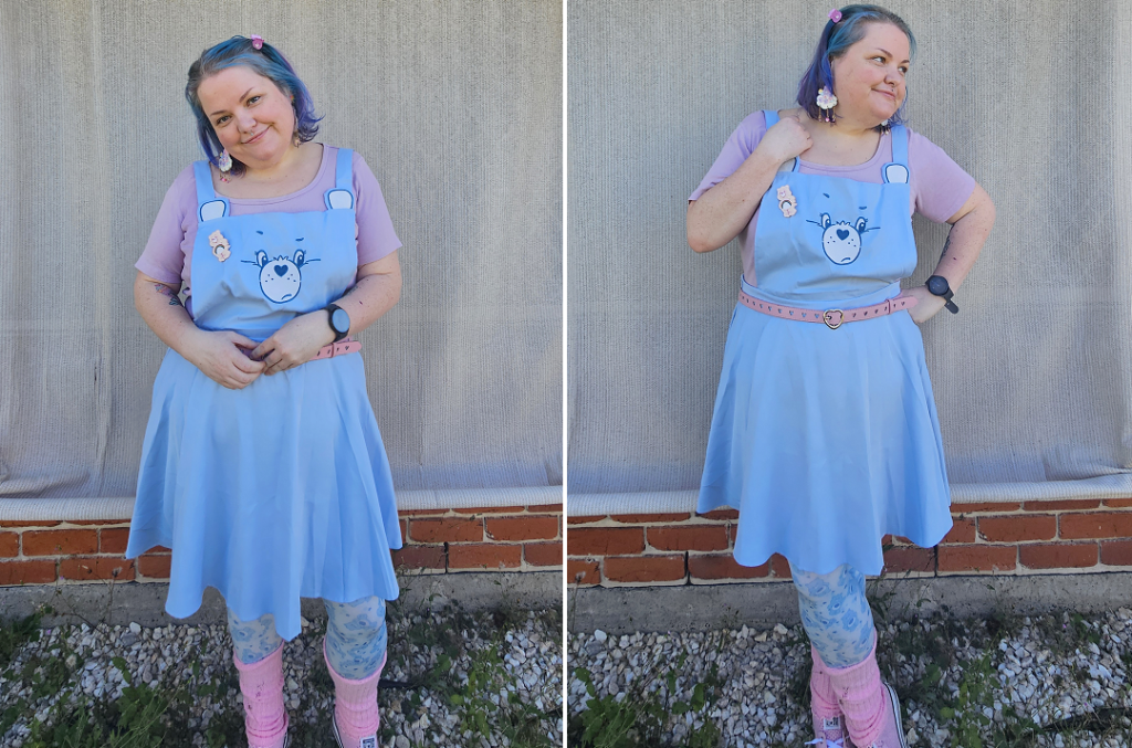 Two images of a size 18 girl with blue hair wearing a care bears outfit, she is outside in front of a cream shade cloth with pebbles and weeds at her feet.